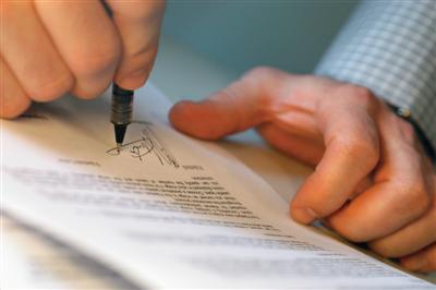 signing papers in home buying process